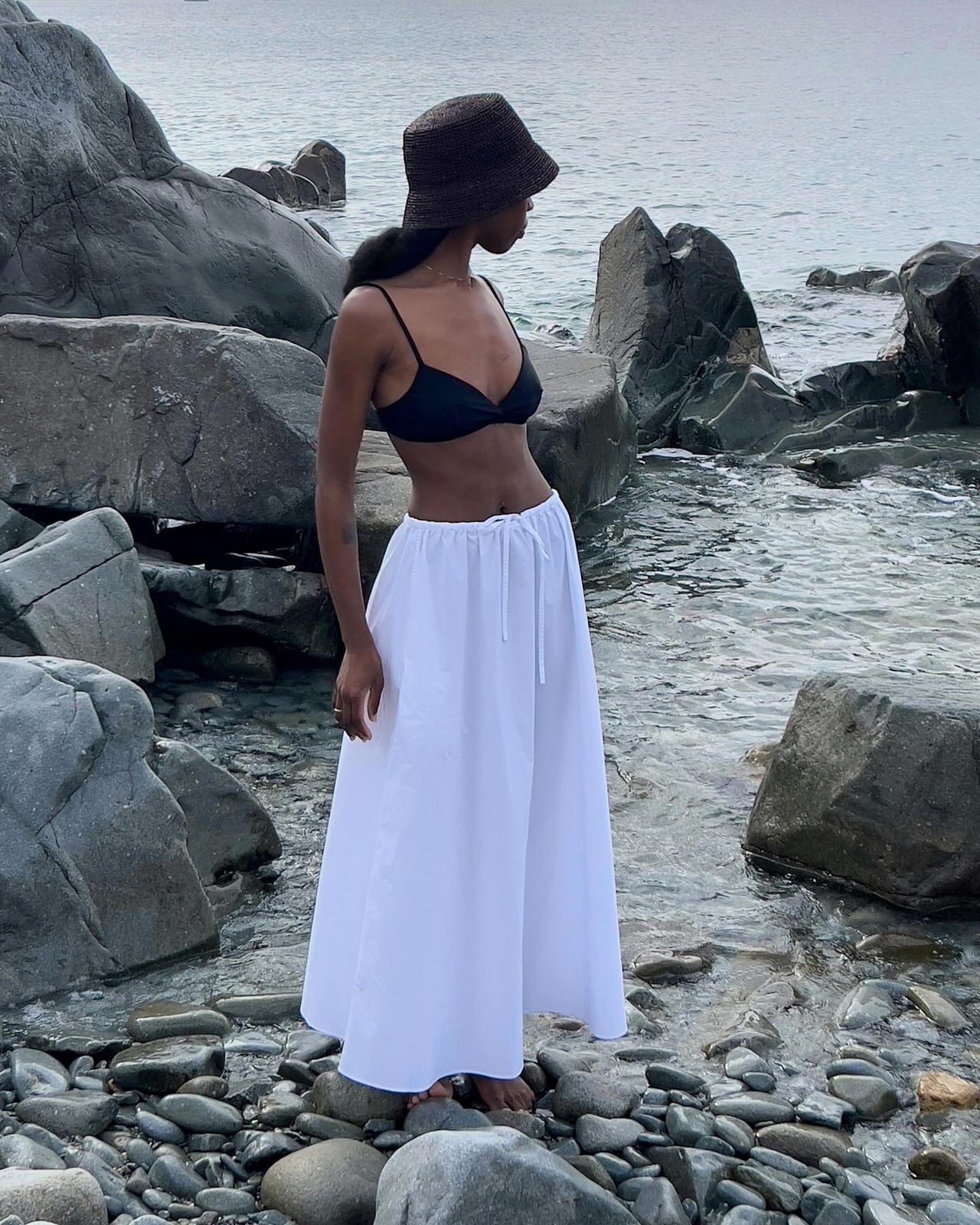 Black Bikini Top with Flowing White Maxi Skirt, Close-Up Take — Trendy Black and White Outfits