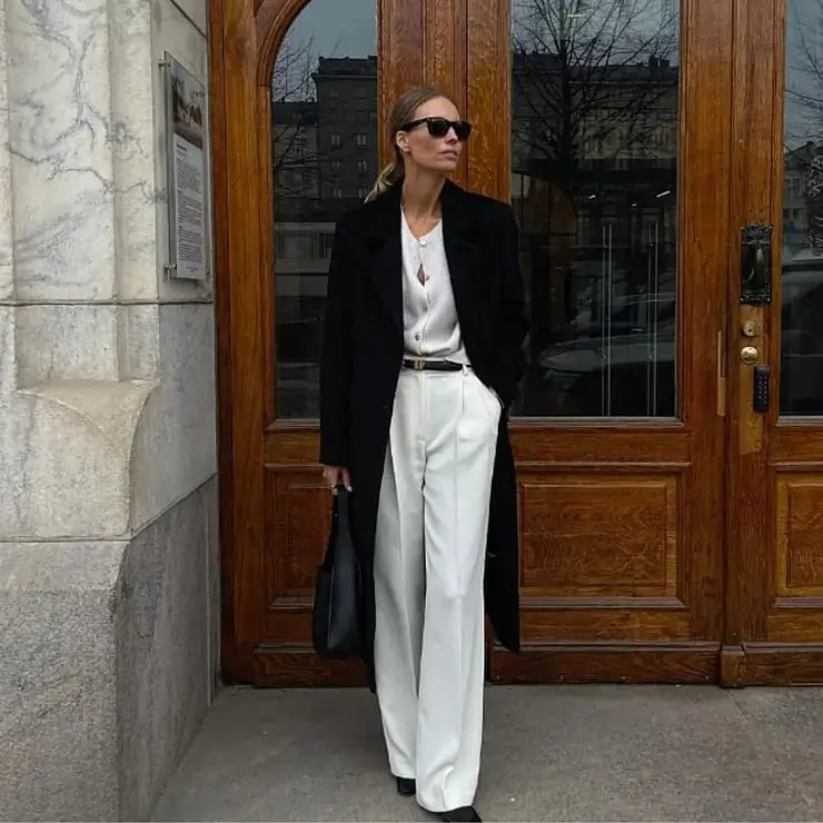 Long Black Coat Over White Blouse and Wide-Leg Trousers — Trendy Black and White Outfits