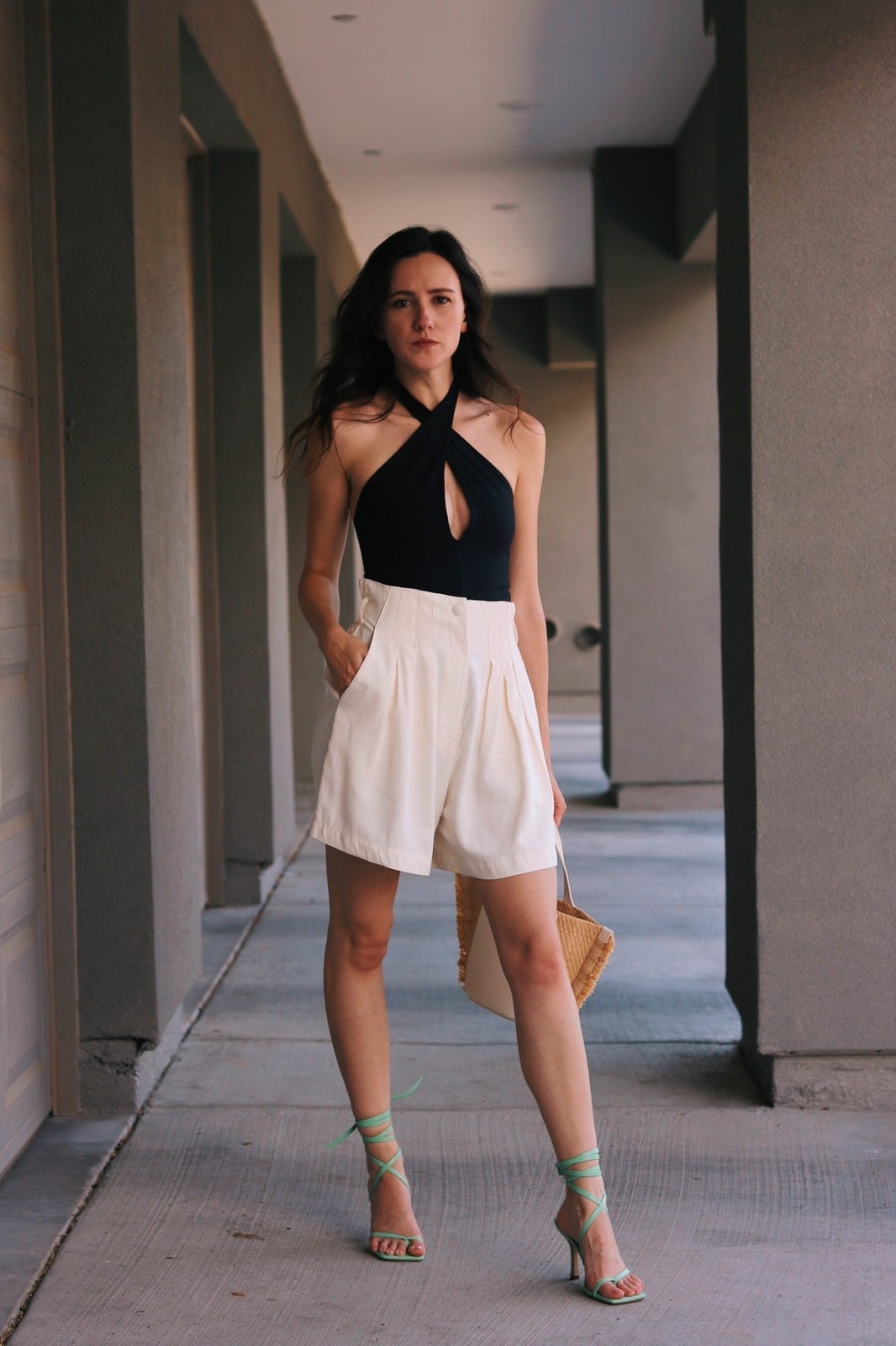Halter Neck Top with Cream Pleated Shorts and Straw Tote Bag — Trendy Black and White Outfits