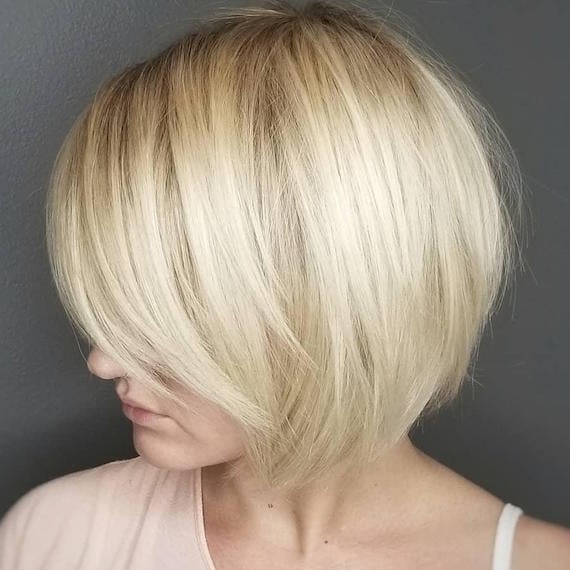 Ash Blonde Bob With Side-Swept Bangs Ash Blonde Bob With Side-Swept Bangs — Trendy Blonde Short Hair