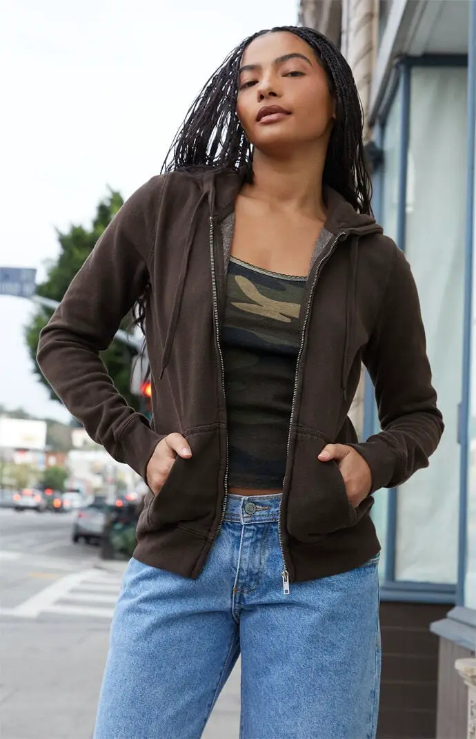Brown Zip-Up Hoodie Over Camouflage Top with Blue Jeans Brown Zip-Up Hoodie Over Camouflage Top with Blue Jeans — Trendy Brown Hoodie Outfit