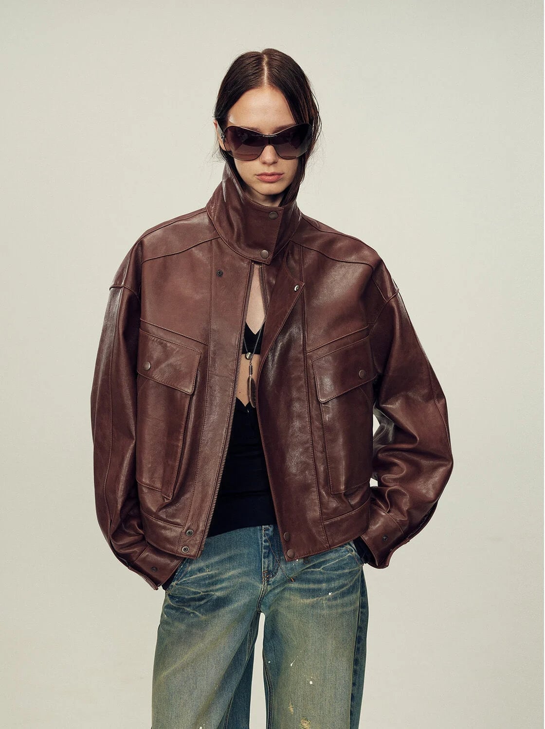 Cropped Brown Leather Jacket with Bra Top and Jeans — Trendy Brown Jacket Outfit
