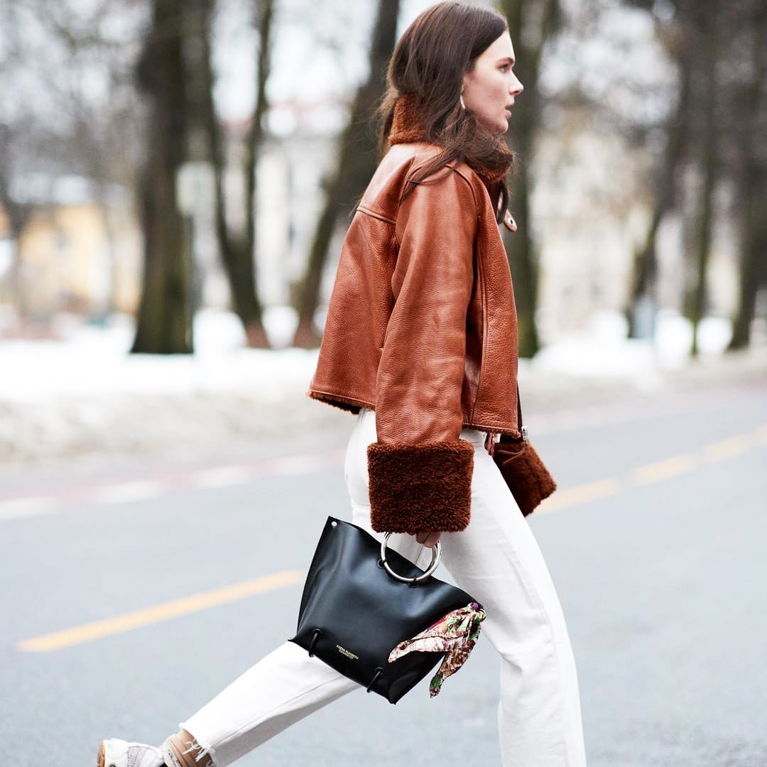 Brown Leather Jacket with Fur Trim Over White Jeans — Trendy Brown Jacket Outfit