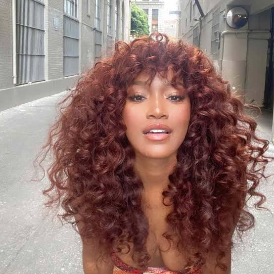 Mid-Back Copper Curls With Auburn Highlights — Trendy Curly Hair Color