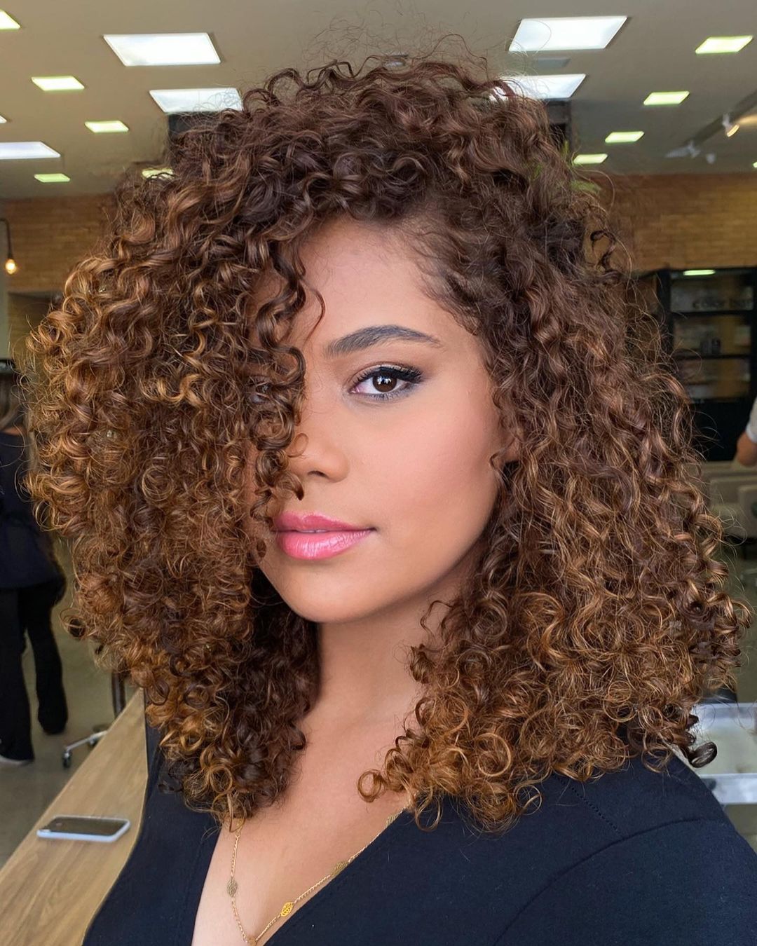 Collarbone Medium Brown With Caramel Balayage, Close-Up Take — Trendy Curly Hair Color