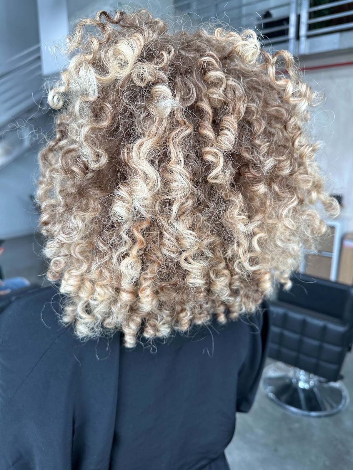 Collarbone Dark Blonde With Ash Blonde Highlights — Trendy Curly Hair Color