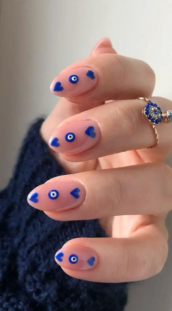 Short Oval Sheer Pink With Blue Evil Eye Hearts — Trendy Evil Eye Nails