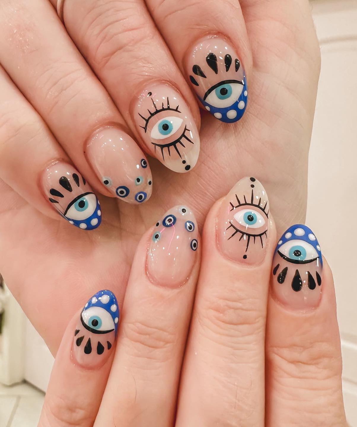 Medium Almond White Nails With Blue Eyes And Gold Stars — Trendy Evil Eye Nails