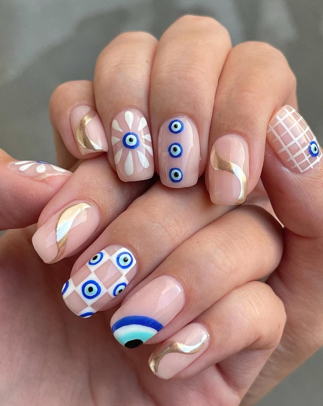Medium Almond White Nails With Blue Eyes And Gold Stars — Trendy Evil Eye Nails