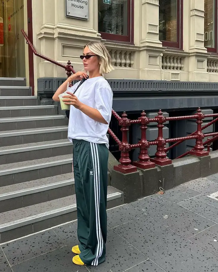Wide Leg Green Track Pants With White T-Shirt and Yellow Sneakers Wide Leg Green Track Pants With White T-Shirt and Yellow Sneakers — Trendy Green Sweatpants Outfit