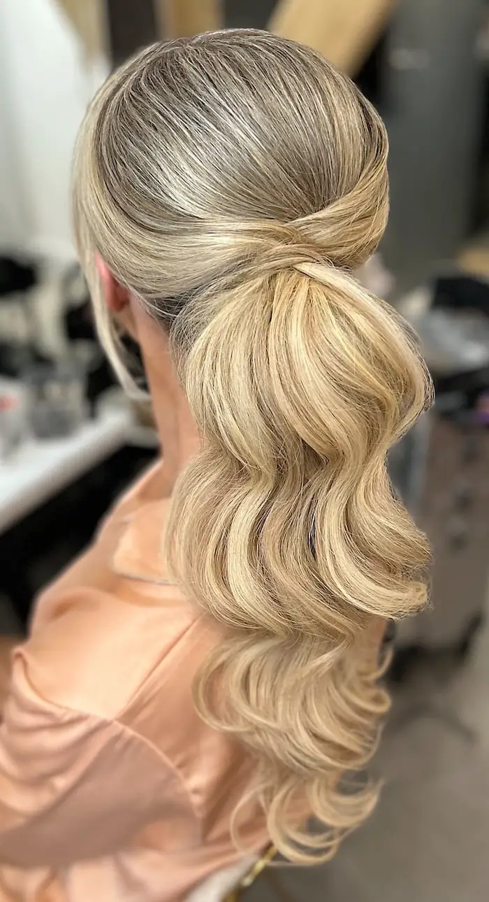 Sleek Ash Blonde Low Ponytail With Voluminous Waves Sleek Ash Blonde Low Ponytail With Voluminous Waves — Trendy Low Ponytail Hairstyles