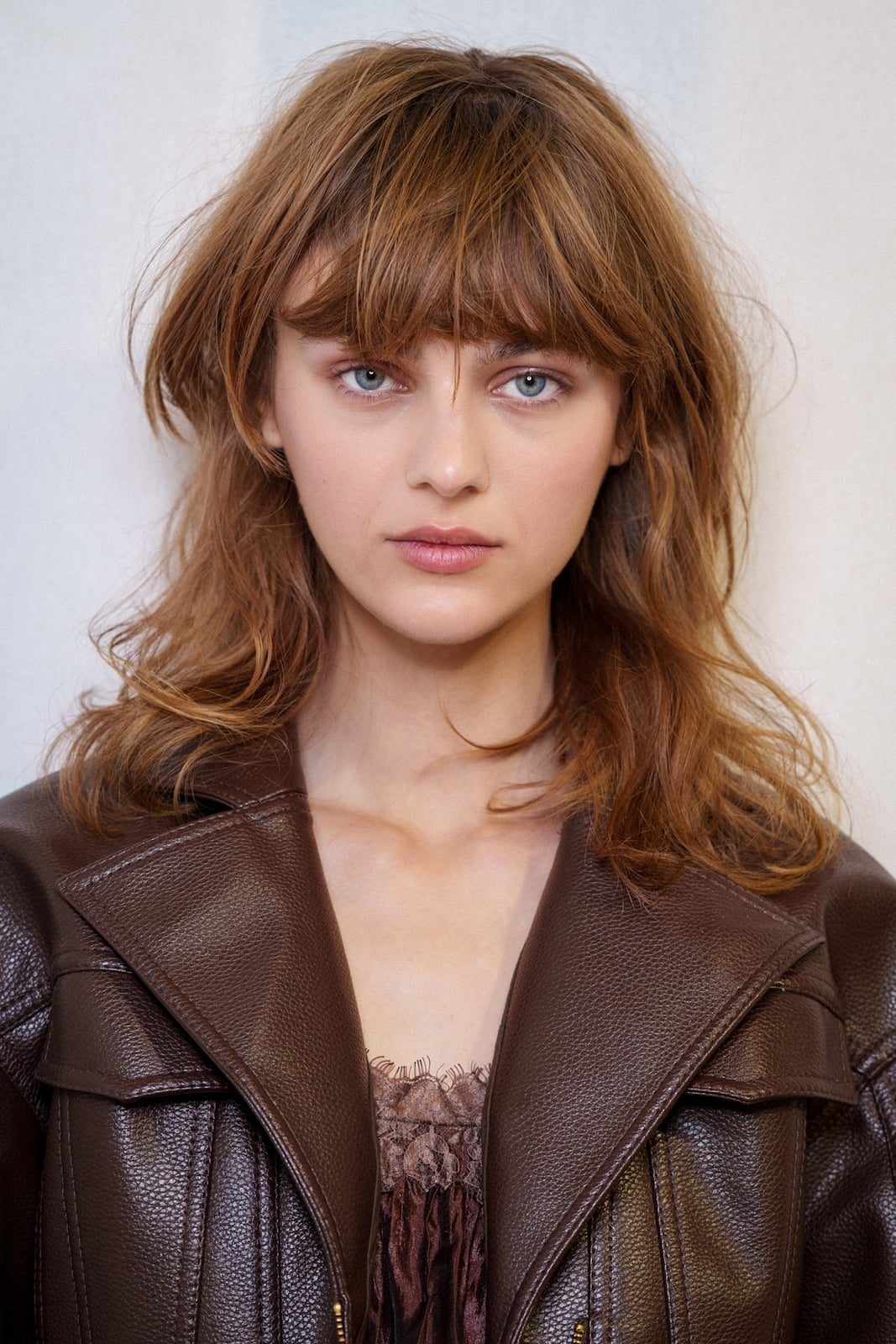 Shoulder-Length Light Brown Shag With Wispy Bangs Shoulder-Length Light Brown Shag With Wispy Bangs — Trendy Modern Shag