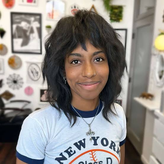 Shoulder-Length Black Shag With Wispy Bangs Shoulder-Length Black Shag With Wispy Bangs — Trendy Modern Shag