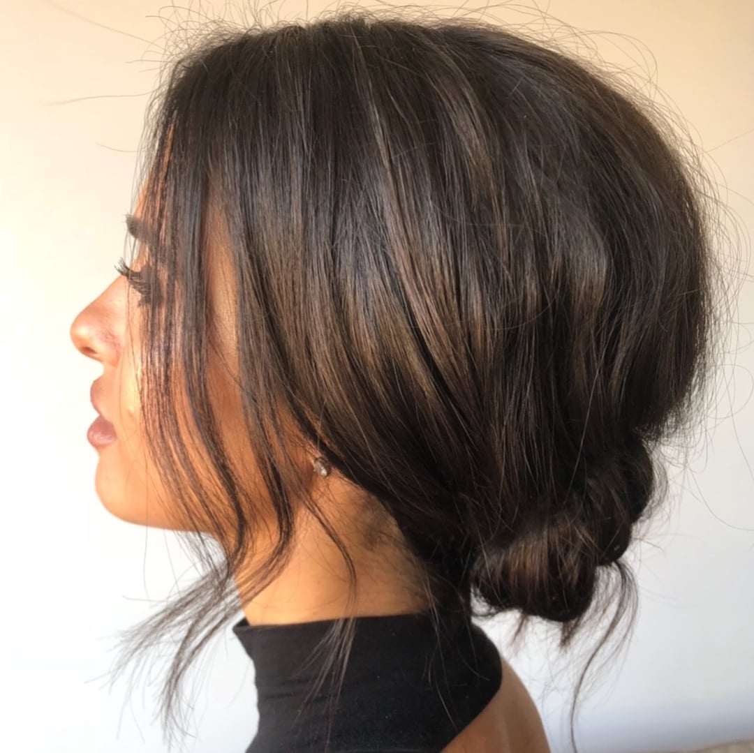 Low Dark Brown Textured Bun With Loose Strands Low Dark Brown Textured Bun With Loose Strands — Trendy Natural Bun
