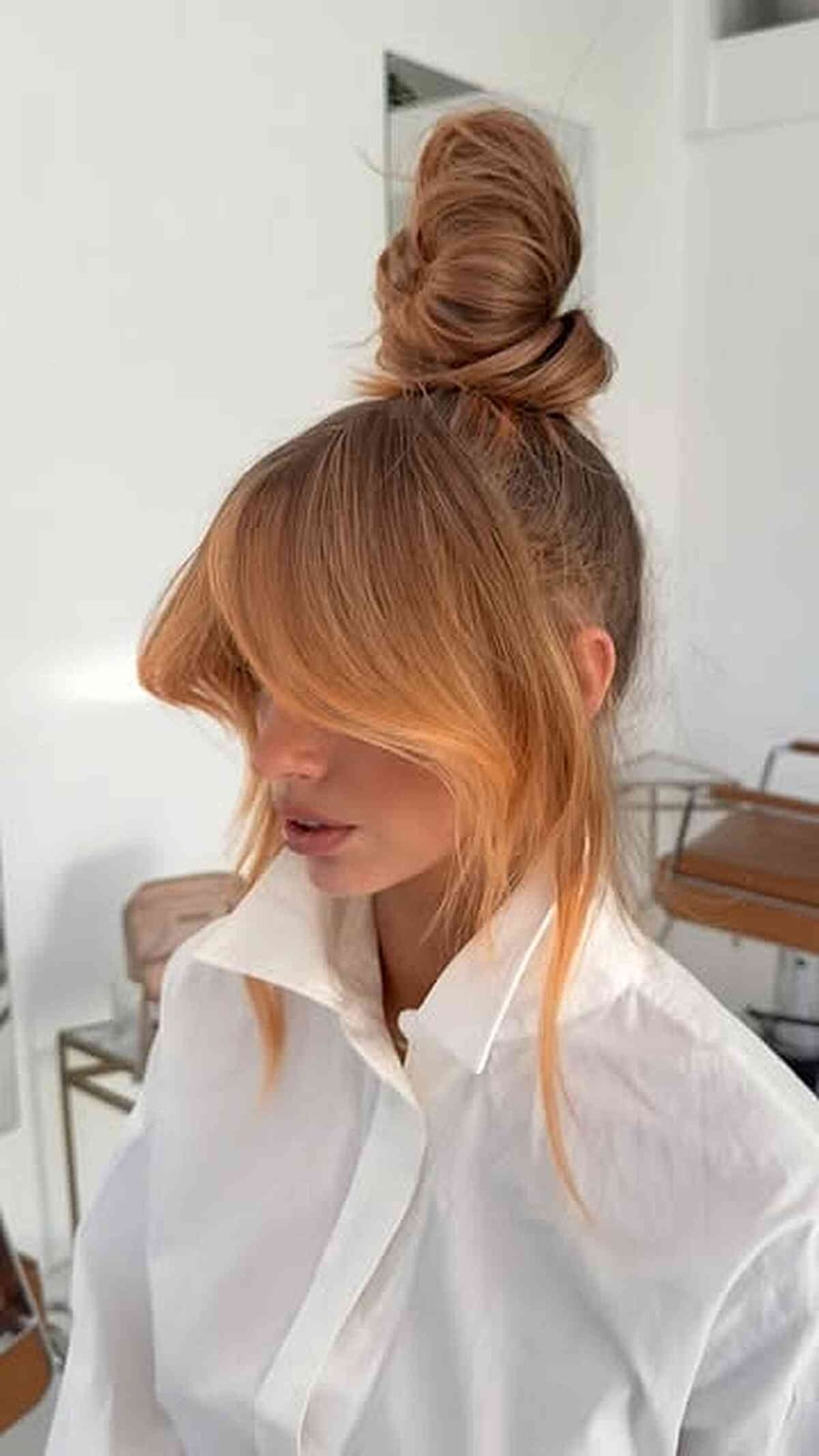Honey Blonde Messy High Bun With Side-Swept Bangs Honey Blonde Messy High Bun With Side-Swept Bangs — Trendy Natural Bun