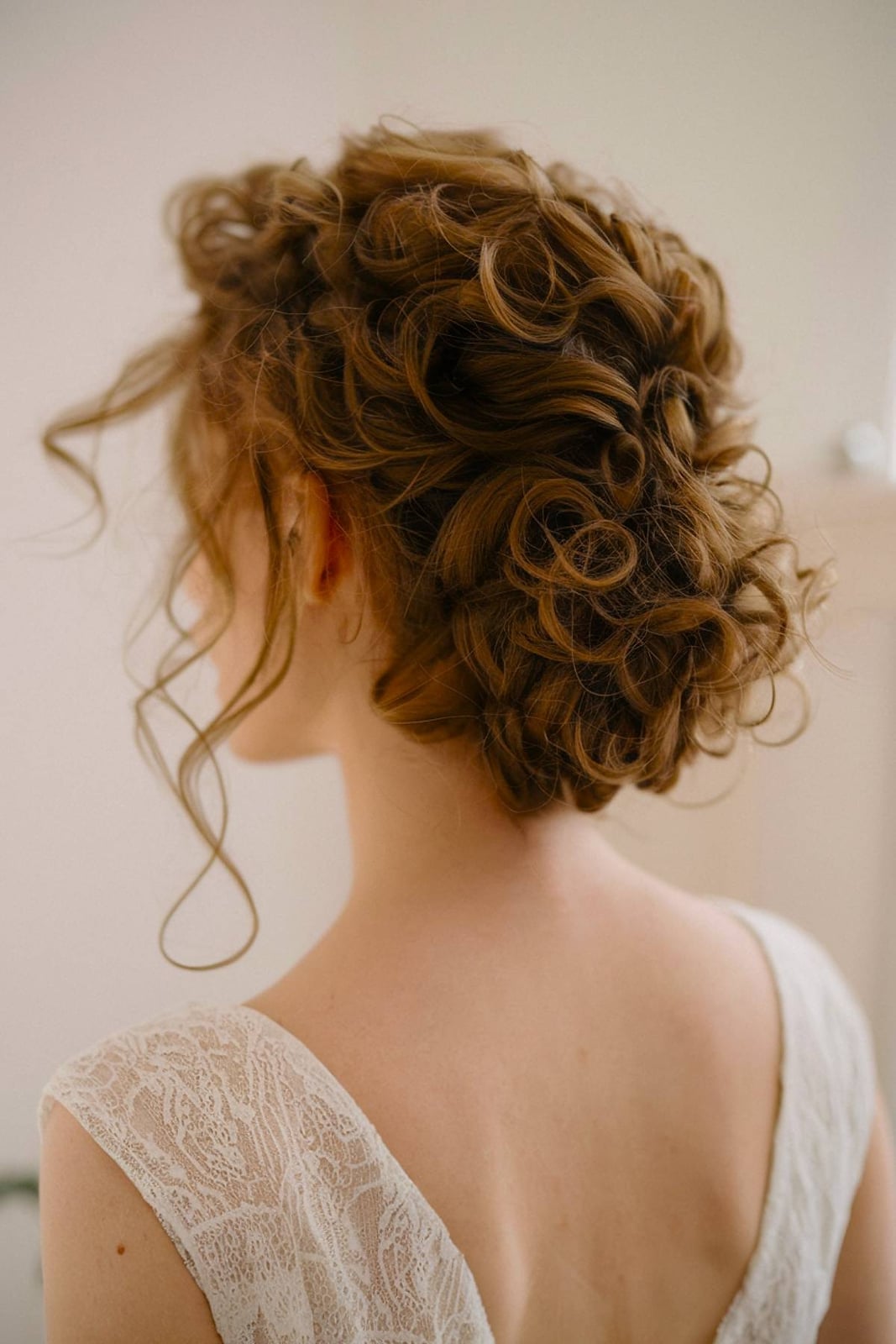 Voluminous Auburn Curly Bun With Curtain Bangs Voluminous Auburn Curly Bun With Curtain Bangs — Trendy Natural Bun