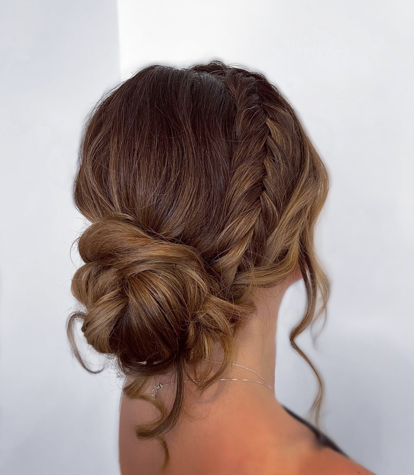 Brunette Messy Bun With Braided Elements Brunette Messy Bun With Braided Elements — Trendy Natural Bun