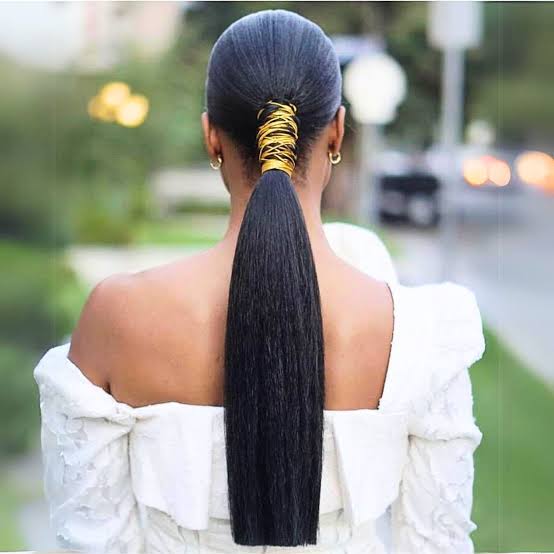 Sleek Black Ponytail With Gold Ribbon Wrap Sleek Black Ponytail With Gold Ribbon Wrap — Trendy Quick Weave Ponytail