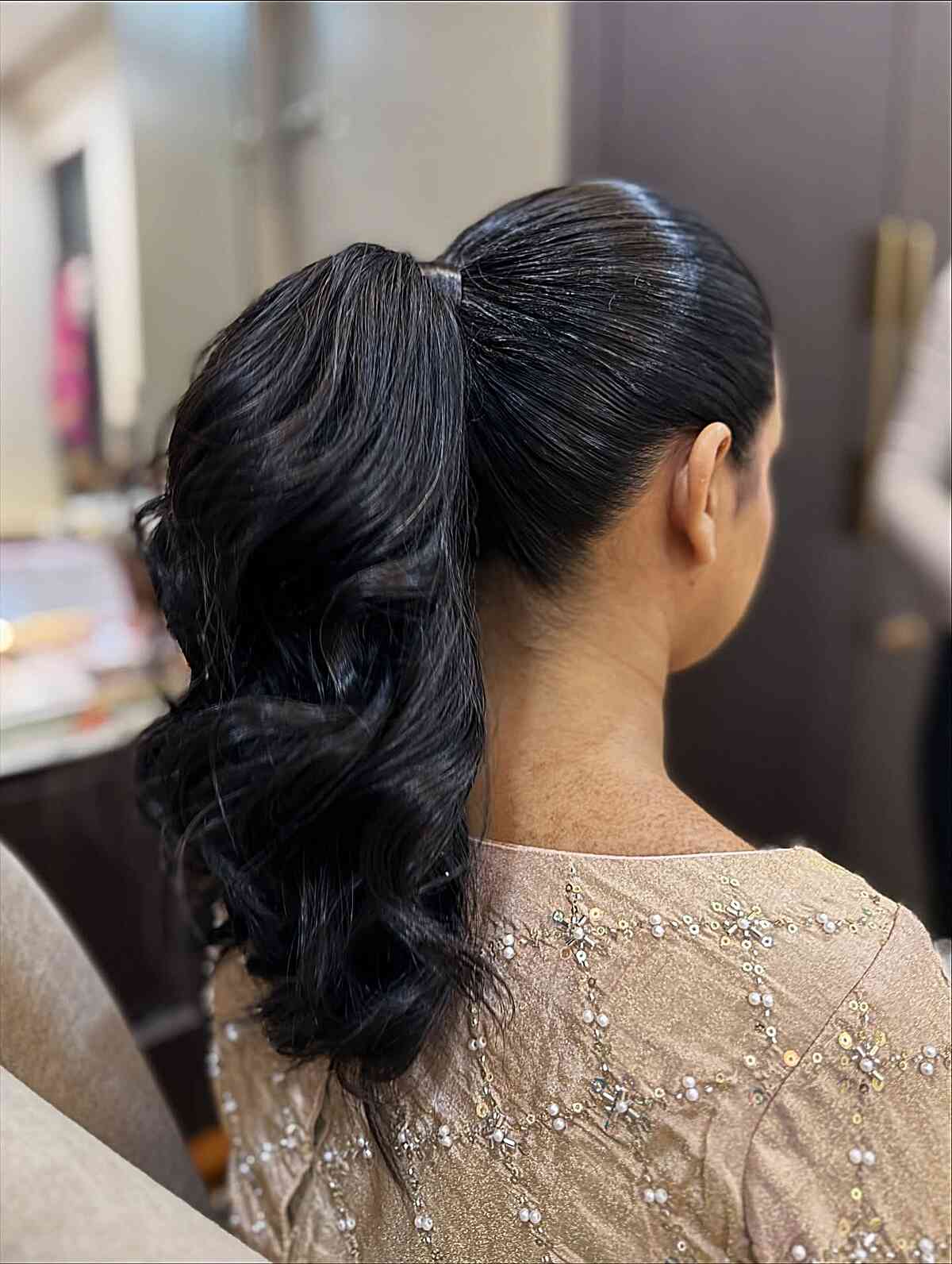 Low Ponytail Wavy Black Collarbone Length — Trendy Sleek Ponytail