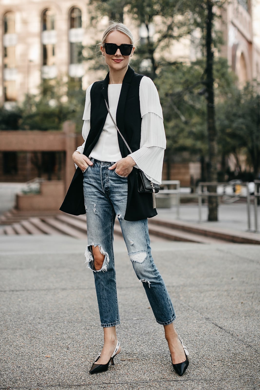 Long Black Vest Over Ruffled Top and Ripped Jeans Long Black Vest Over Ruffled Top and Ripped Jeans — Trendy Vest Outfits